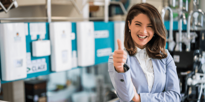 Lady product owner in her executive dress smiling and giving thumbs up. 